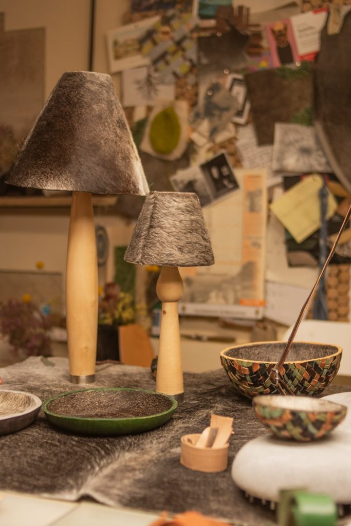 a-table-topped-with-a-bowl-and-two-lamps-2gcvhmcxvta
